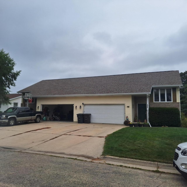 view of front of property featuring a garage and a front lawn