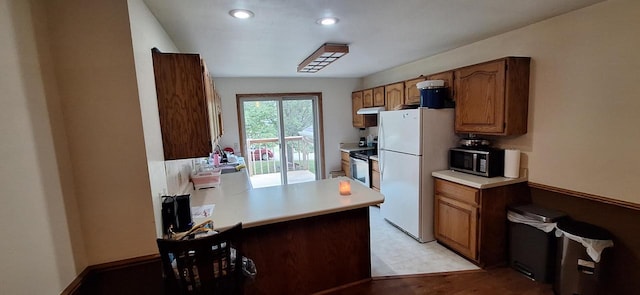 kitchen with appliances with stainless steel finishes and kitchen peninsula