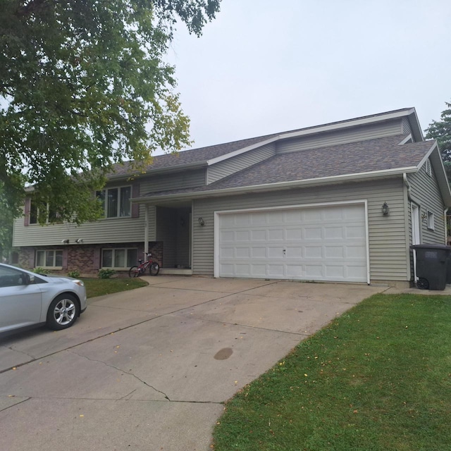 view of front of house with a garage and a front lawn