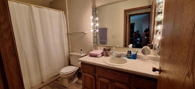 bathroom with vanity, toilet, and walk in shower