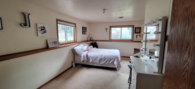 bedroom featuring multiple windows and carpet flooring