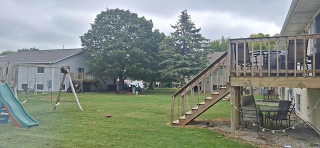 view of playground with a yard and a deck