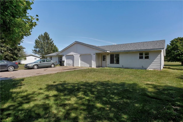 ranch-style house featuring a garage and a front yard