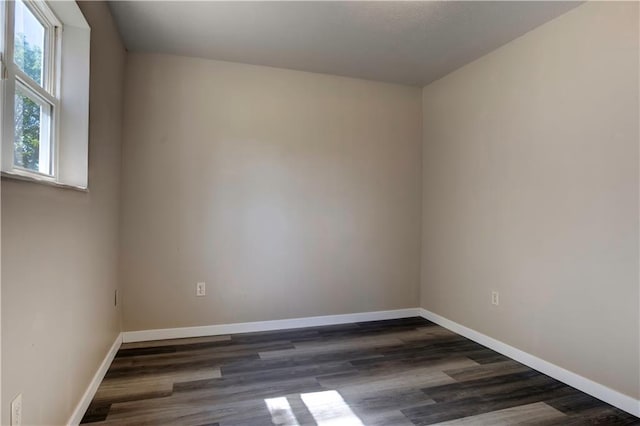 spare room featuring dark hardwood / wood-style flooring