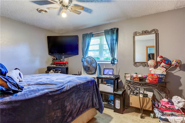 carpeted bedroom with a textured ceiling and ceiling fan