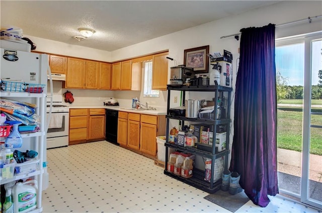 kitchen with a textured ceiling, sink, and white appliances