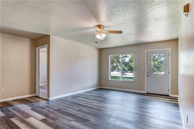 spare room featuring ceiling fan, dark hardwood / wood-style floors, and a textured ceiling