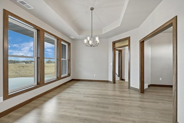 1630 N Honeysuckle Cir, De Pere, WI 54115 - unfurnished dining area with a tray ceiling, visible vents, baseboards, and light wood finished floors