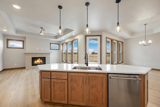 1630 N Honeysuckle Cir, De Pere, WI 54115 - kitchen featuring light wood-style flooring, a sink, a tray ceiling, open floor plan, and dishwasher
