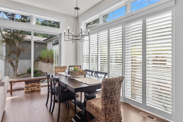 dining space featuring a notable chandelier and wood-type flooring