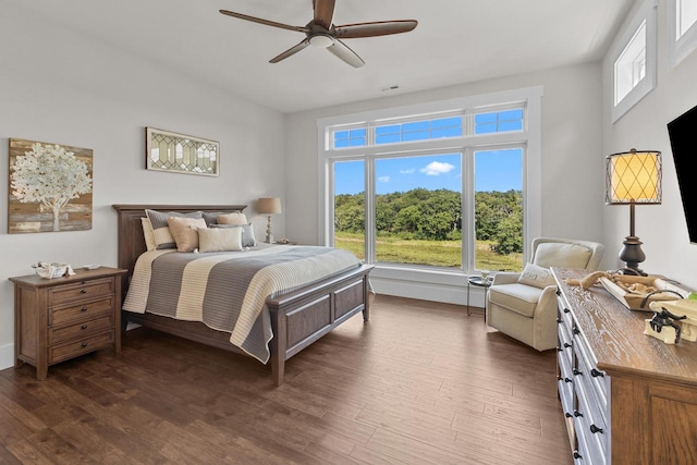 bedroom featuring multiple windows, ceiling fan, and dark hardwood / wood-style floors