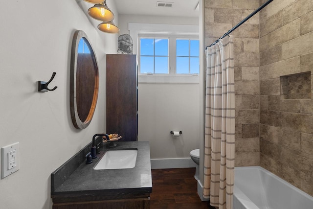 full bathroom with vanity, toilet, wood-type flooring, and shower / bath combo