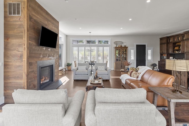 living room featuring a fireplace and dark wood-type flooring