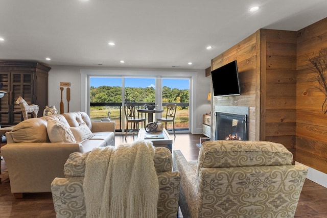 living room featuring dark hardwood / wood-style flooring and wood walls