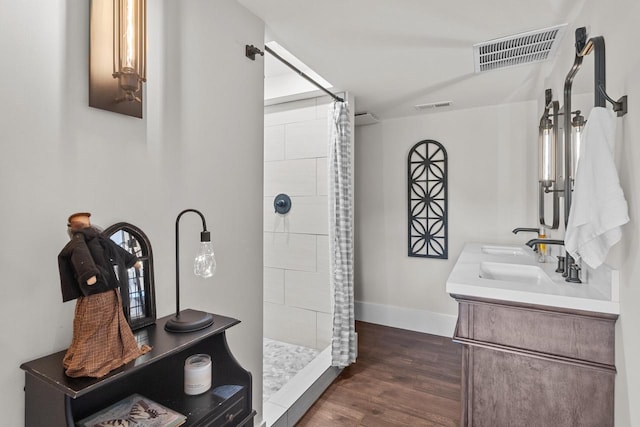 bathroom featuring vanity, hardwood / wood-style floors, and walk in shower