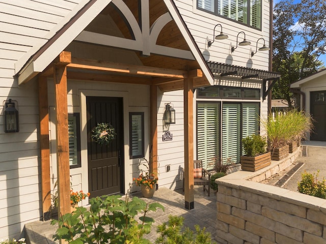 entrance to property with a pergola