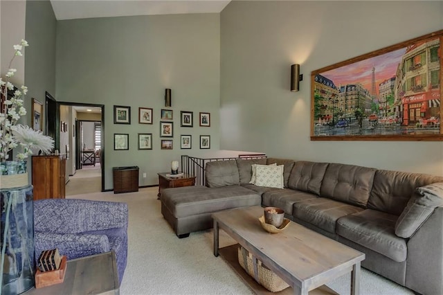 living room featuring high vaulted ceiling and light colored carpet