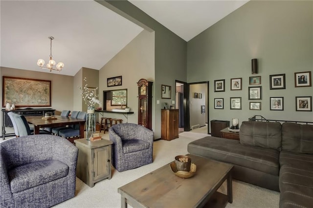 carpeted living room with high vaulted ceiling and an inviting chandelier