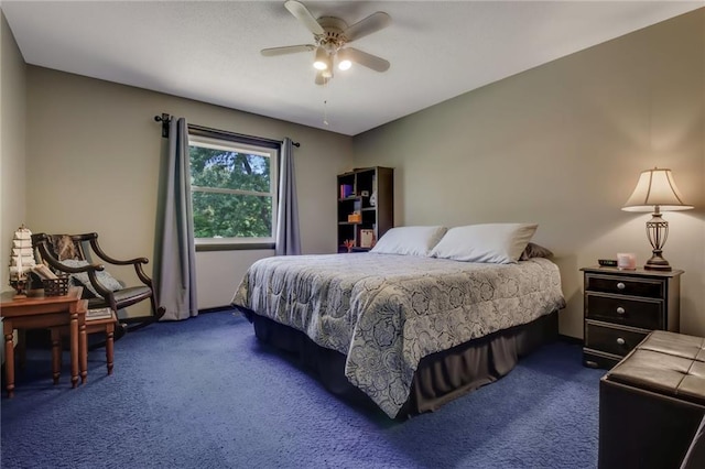 bedroom with ceiling fan and dark colored carpet