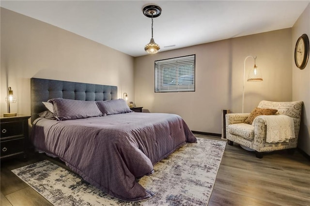 bedroom with dark hardwood / wood-style floors