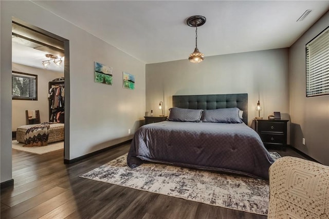 bedroom with dark hardwood / wood-style flooring