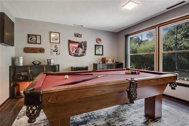 game room with a textured ceiling, hardwood / wood-style floors, and pool table