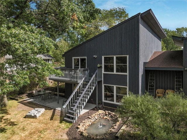 back of property featuring a patio and a deck