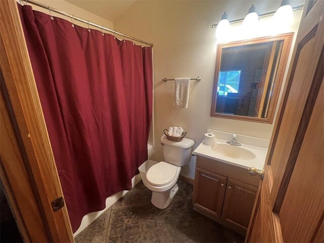 full bathroom featuring tile patterned flooring, toilet, shower / tub combo with curtain, and vanity