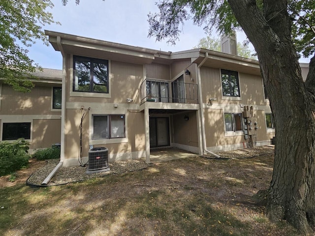 rear view of house with central air condition unit