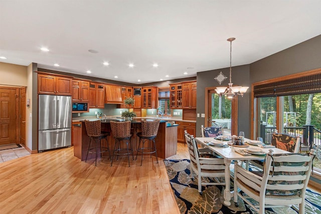 dining space with a chandelier and light hardwood / wood-style floors