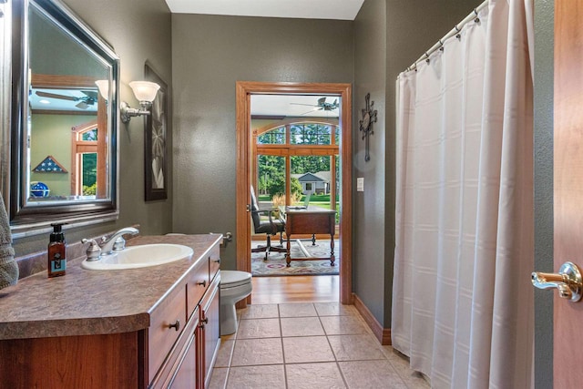 bathroom with vanity, toilet, ceiling fan, and hardwood / wood-style flooring