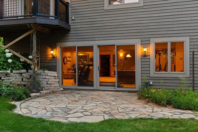 property entrance featuring a balcony and a patio