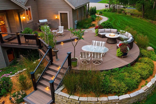 deck featuring an outdoor fire pit and grilling area