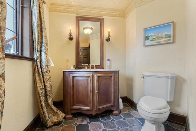 bathroom featuring vanity, toilet, and ornamental molding