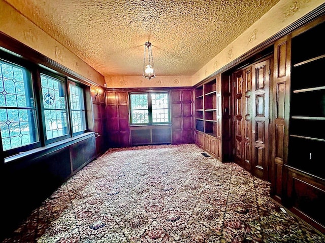 interior space with a chandelier and a textured ceiling