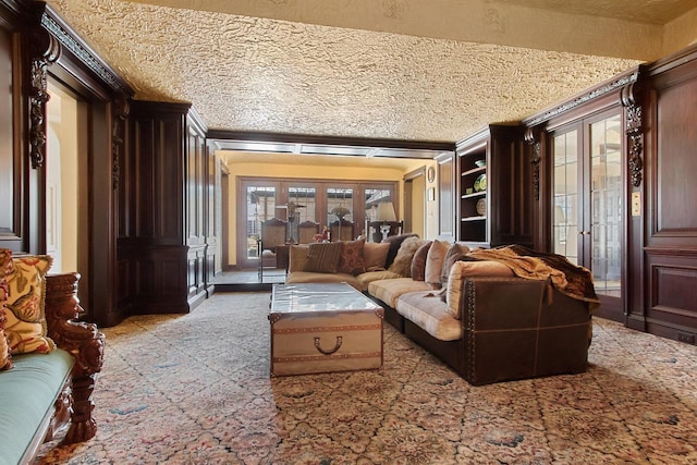 living room featuring a wealth of natural light, a textured ceiling, and french doors