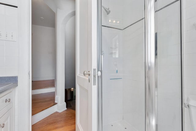 bathroom featuring vanity, a shower with shower door, and hardwood / wood-style flooring