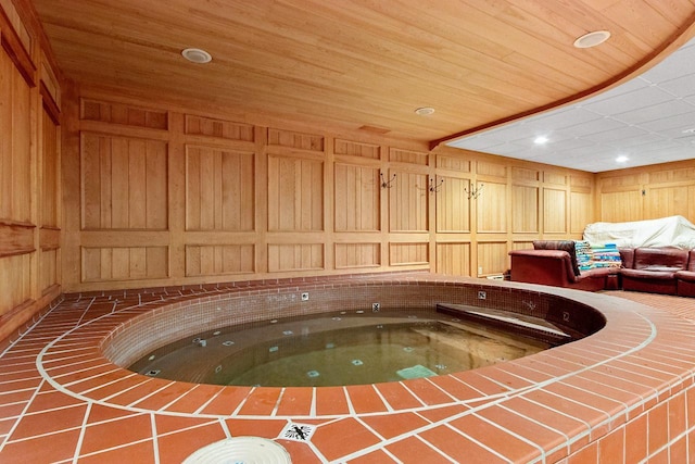 view of pool with an indoor hot tub