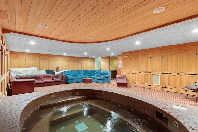 view of swimming pool featuring an indoor hot tub