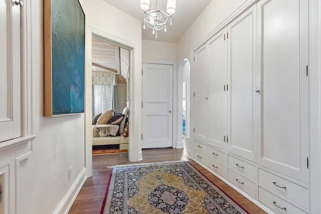 interior space featuring dark wood-type flooring and a chandelier