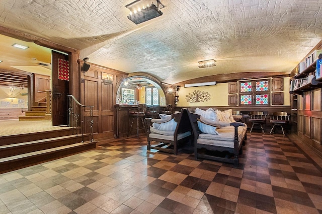 living area with wooden walls