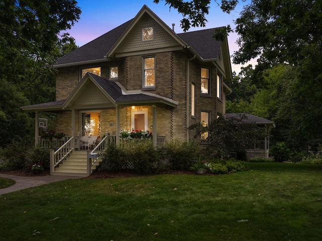 view of front of property featuring a yard and a porch