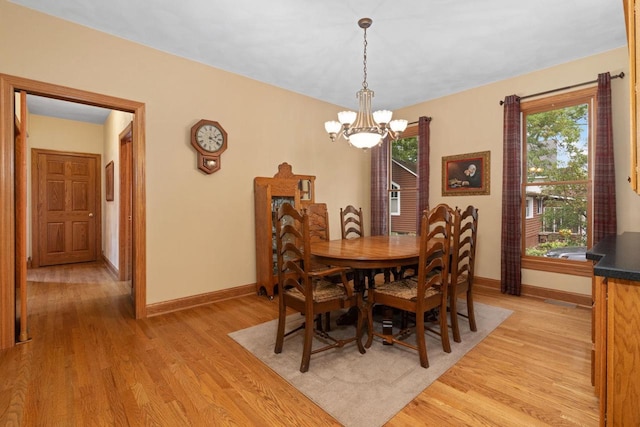 dining space featuring a chandelier and light hardwood / wood-style flooring