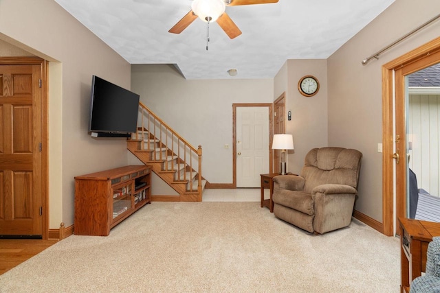 living area with carpet and ceiling fan