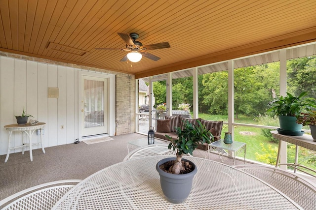 sunroom with ceiling fan and wood ceiling