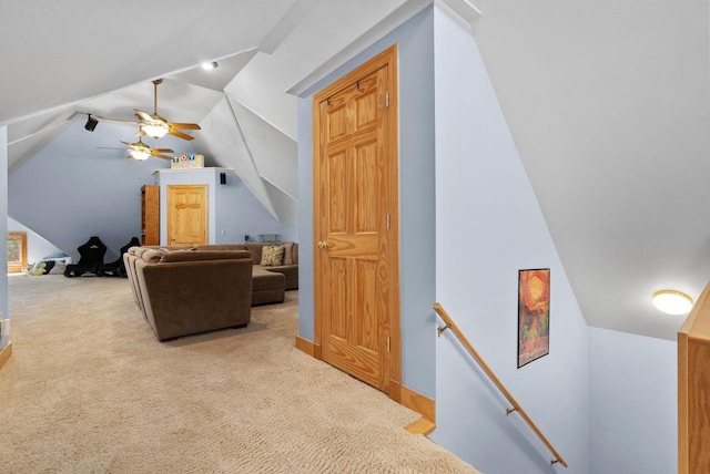 additional living space with ceiling fan, light colored carpet, and lofted ceiling