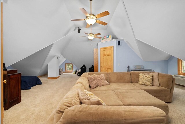 carpeted living room with vaulted ceiling and ceiling fan