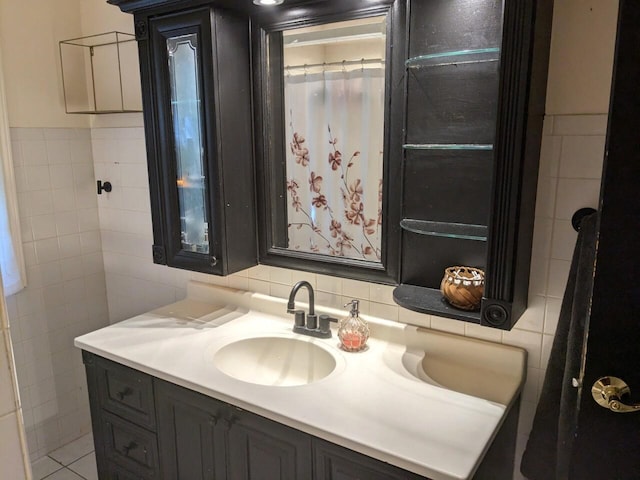 bathroom with tile patterned floors, vanity, and tile walls