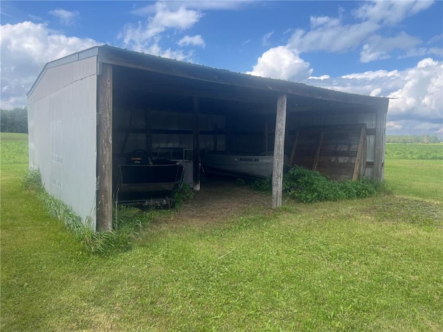 view of outbuilding featuring a yard and a rural view