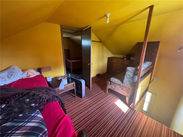 bedroom featuring vaulted ceiling and carpet